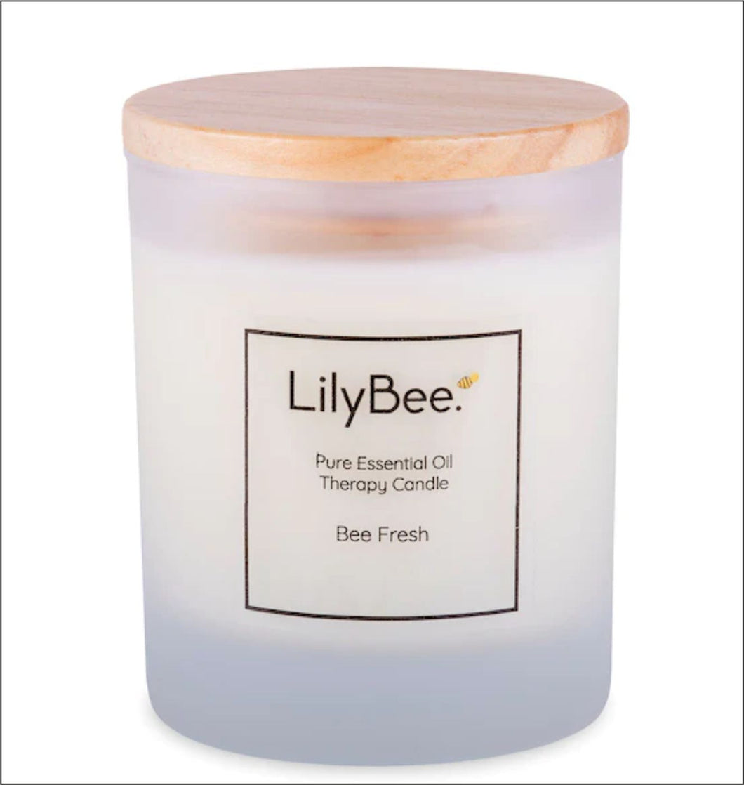 LilyBee essential oil candle - Bee Fresh - in a frosted glass container with bamboo lid.